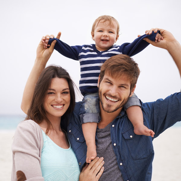 family of three smiling together