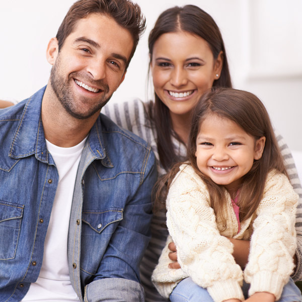 family of three smiling together