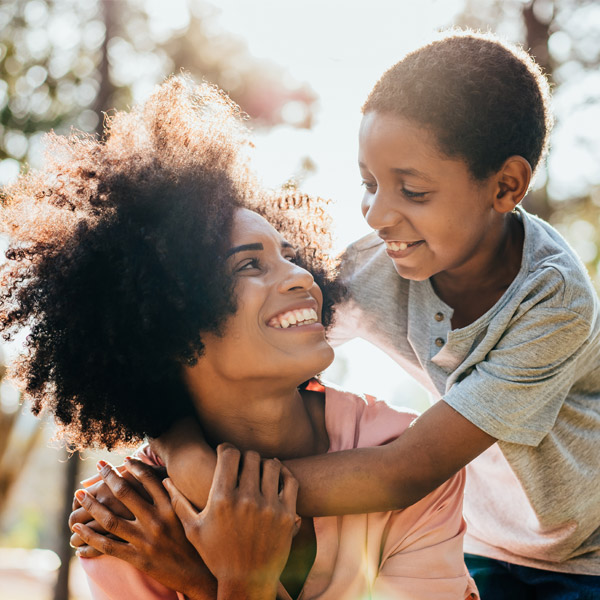 mother and son smiling together outside