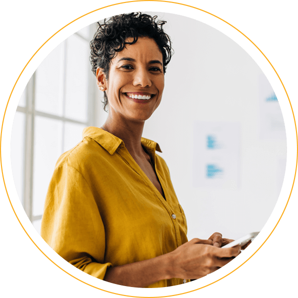 woman smiling and holding cell phone