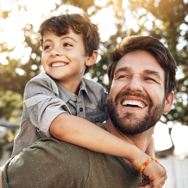 father and son smiling together